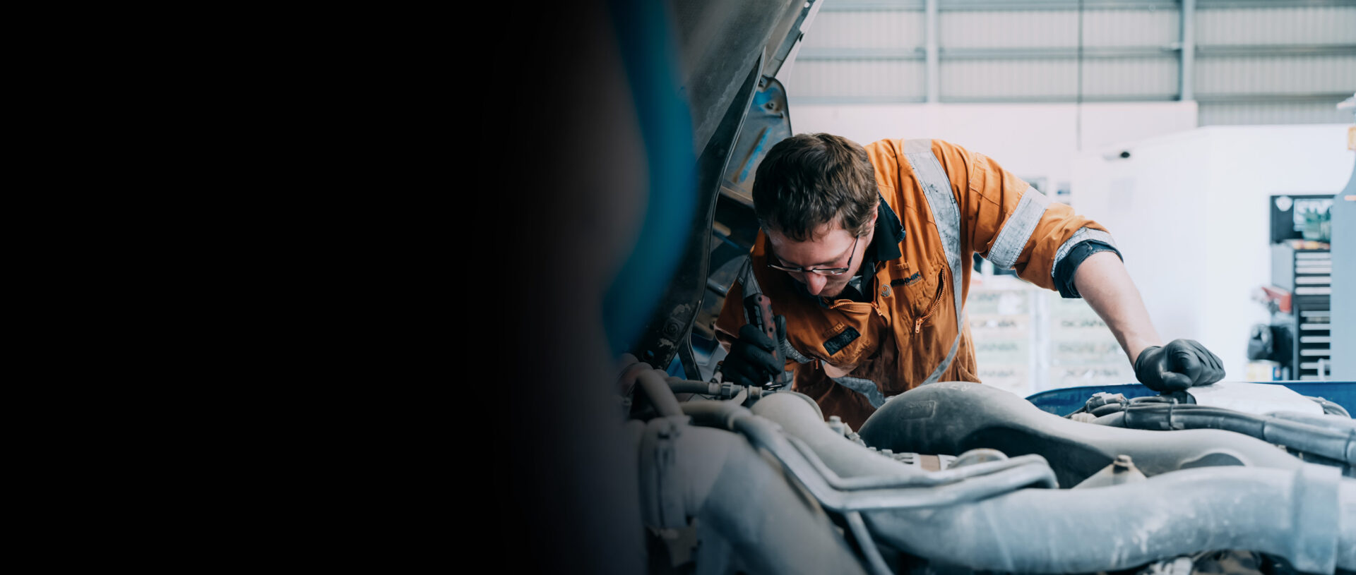 IA-28 Broshmik Mechanic working on a Truck Engine Bay